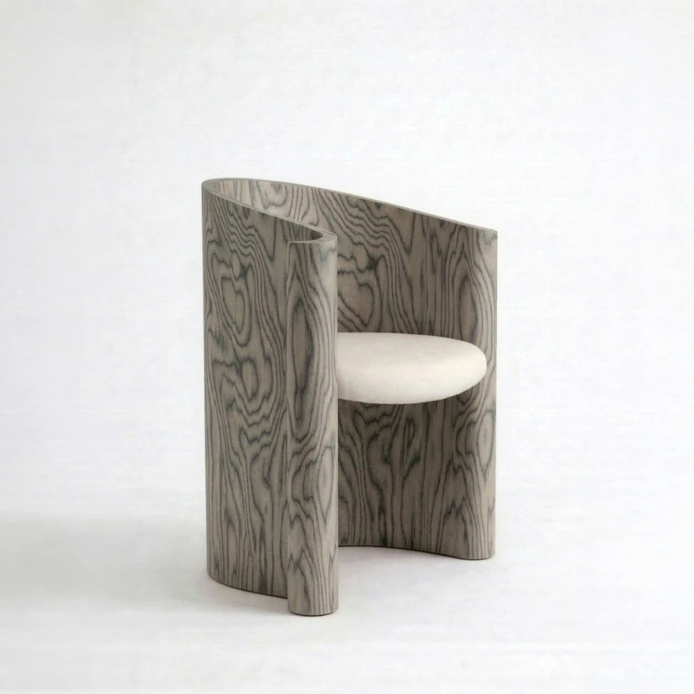 Volute Chair by Garnier Pingree in the Sottsass finish, with dark wavy grain across a grey wooden shell and a cream seat.